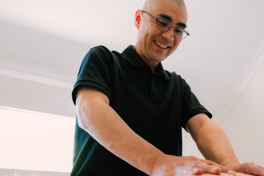 Remedial massage therapist performing deep tissue treatment at allied health clinic in Perth WA