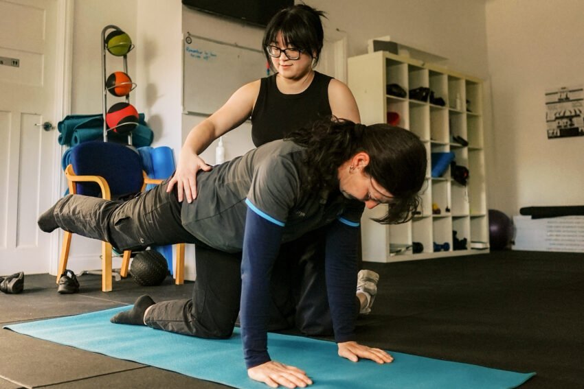 Chiropractor guiding back rehabilitation exercises at The Wellness Place in Bassendean